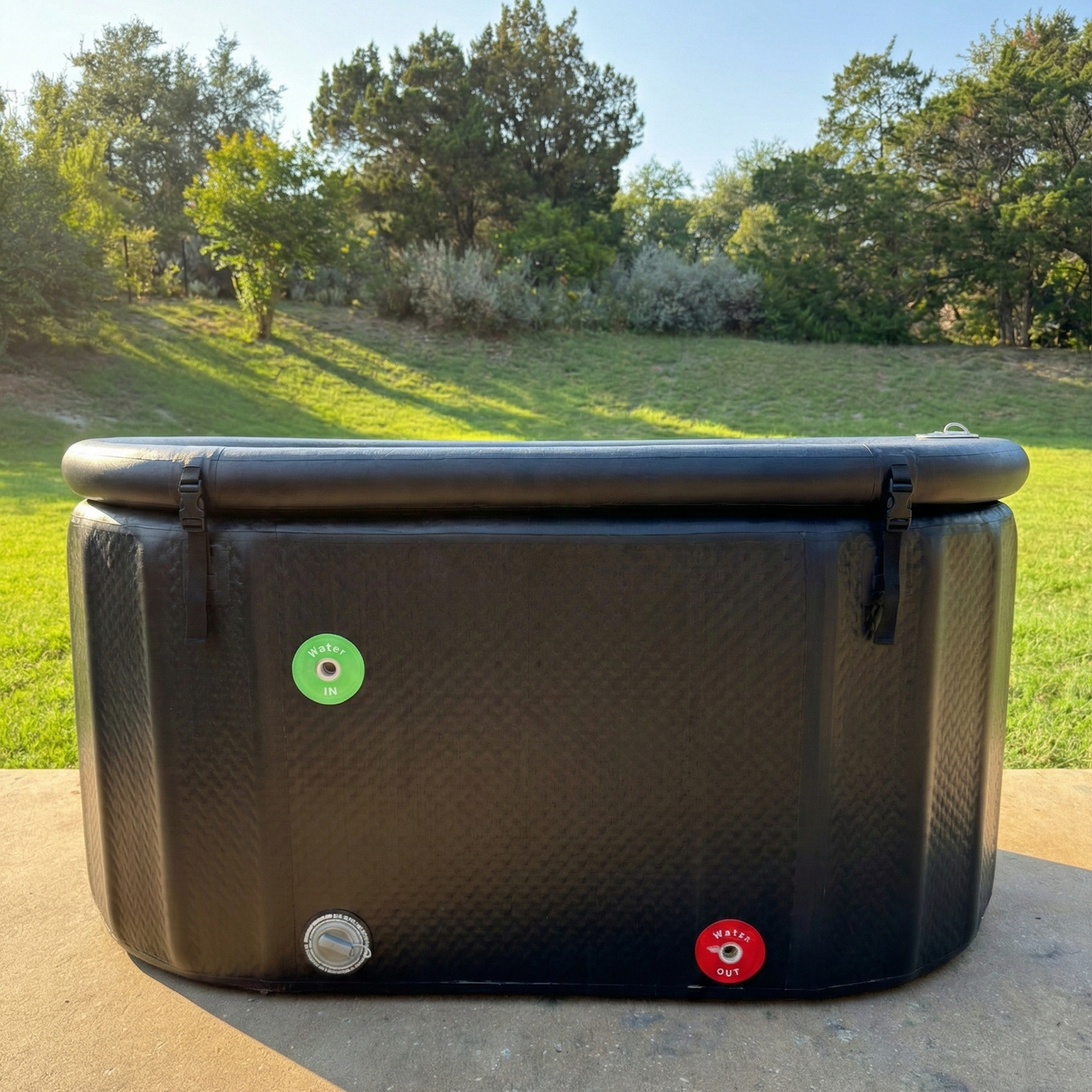 Black XL Ice Tub for cold plunge. On outdoor patio during sunny day.