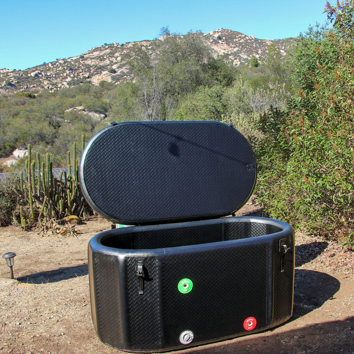Inflatable cold plunge tub with the insulated lid open, showing the interior and depth