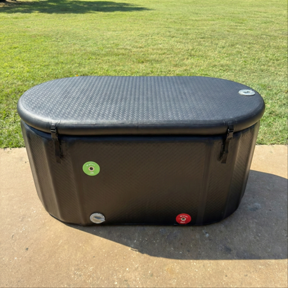 XL Black ice tub for cold plunge on a concrete surface with grass in the background